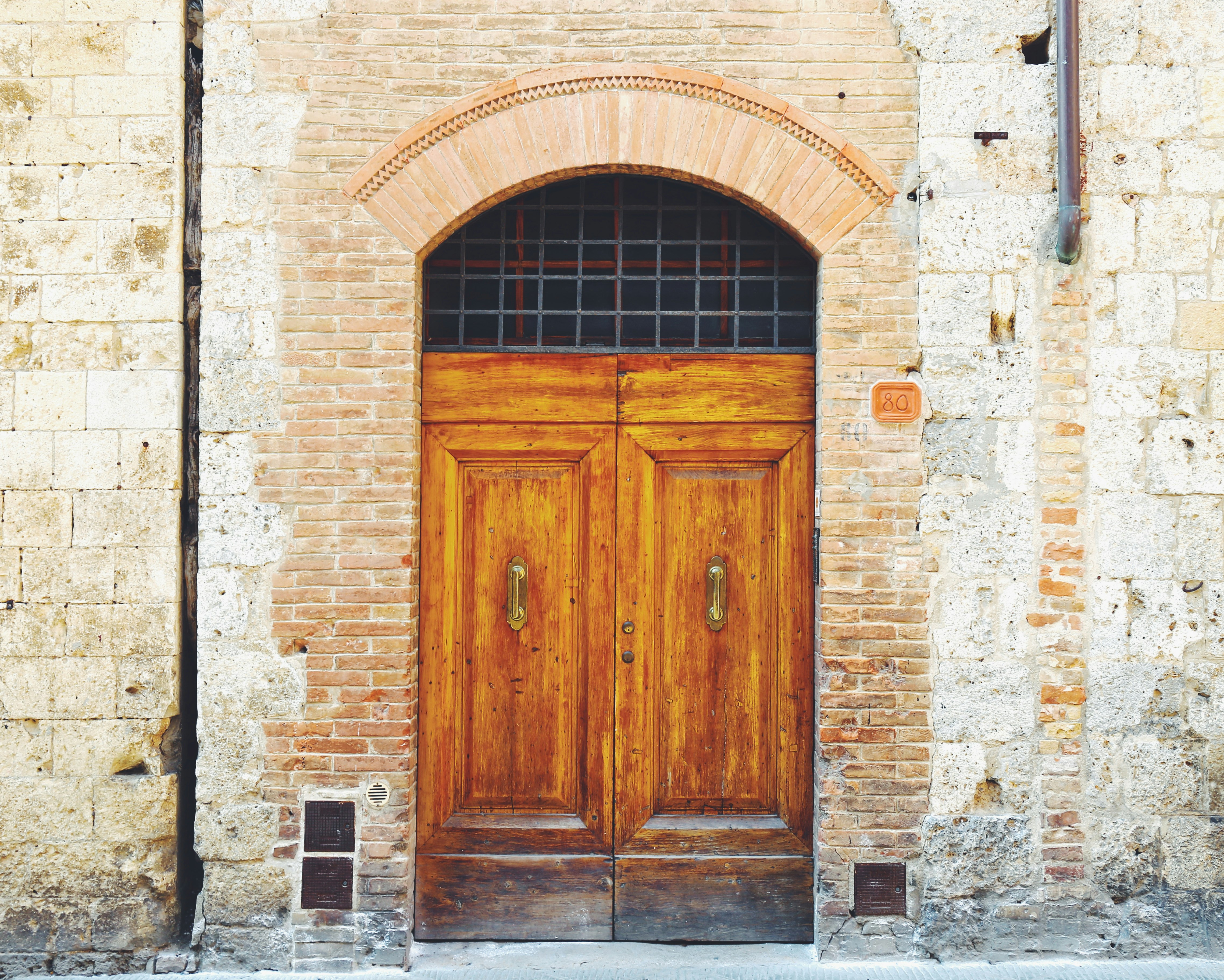 brown wooden door on gray concrete building